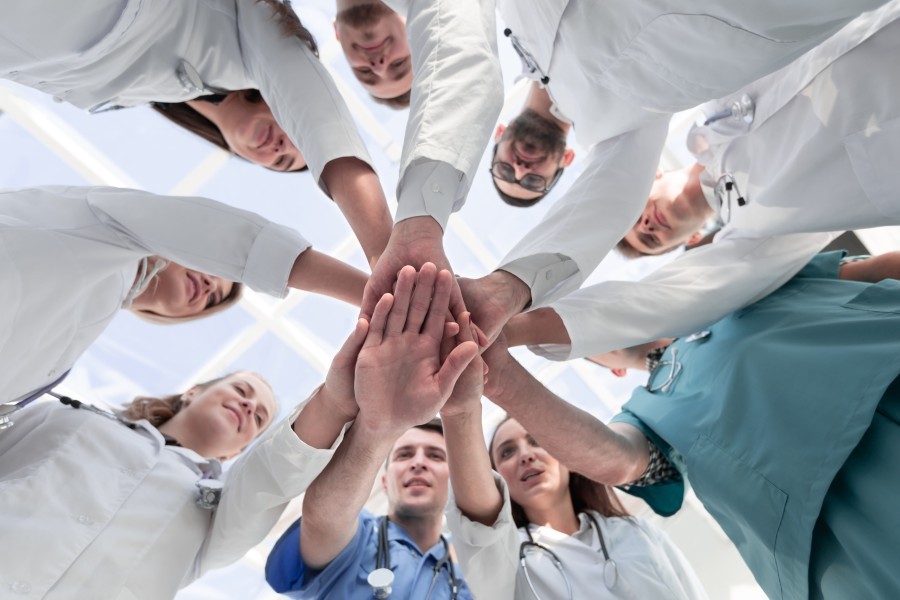 Medical Professionals Putting Hands in a Circle